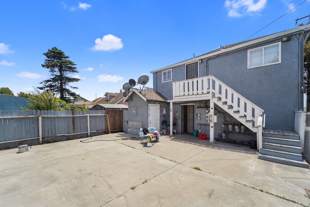 A house with a garage and a tree in the backyard.