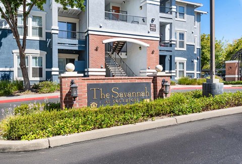 The Savannah at Southridge is a multi-story residential building with a blue and white exterior.