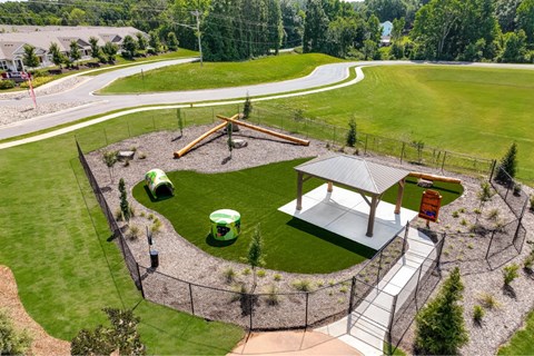 A green field with a pavilion and a playground.