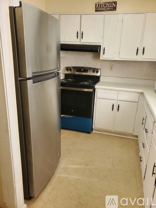 A kitchen with a refrigerator and stove.