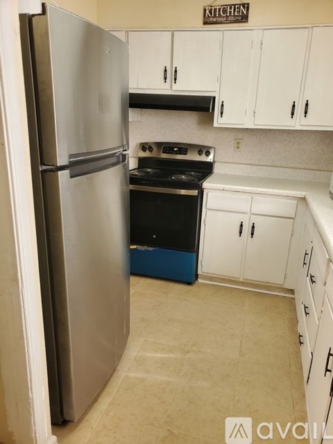 A kitchen with a refrigerator and stove.