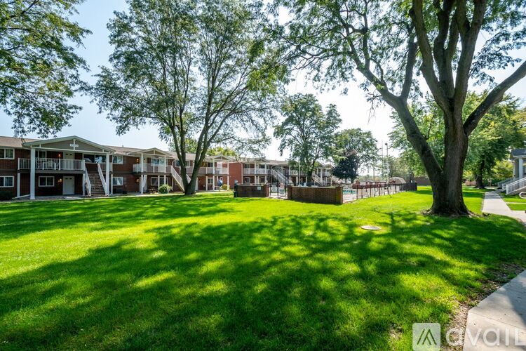 A grassy area in front of apartment buildings.