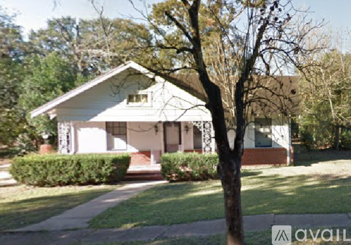 A house with a tree in front of it.