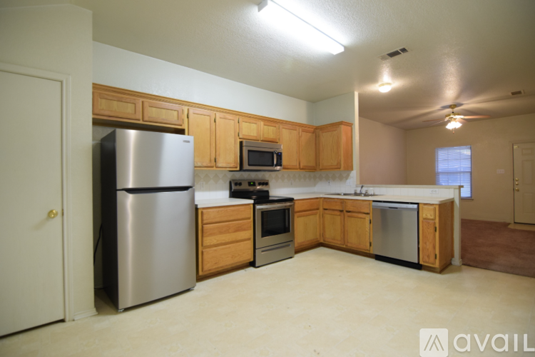A kitchen with wooden cabinets and stainless steel appliances.