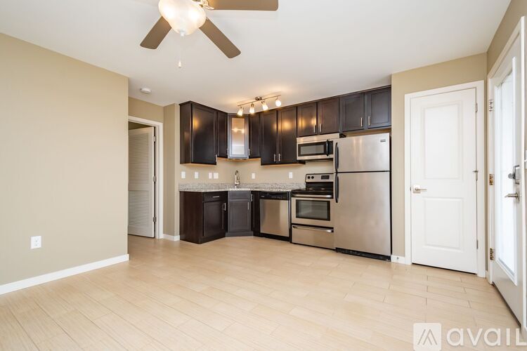 A kitchen with a refrigerator, oven, and microwave.