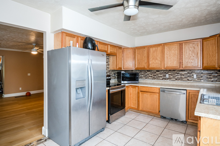 A kitchen with a refrigerator, stove, and oven.