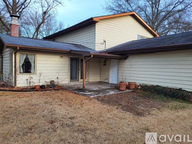A house with a brown roof and a covered patio.