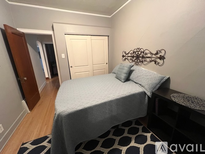 A bedroom with a large bed and a mirror on the wall.