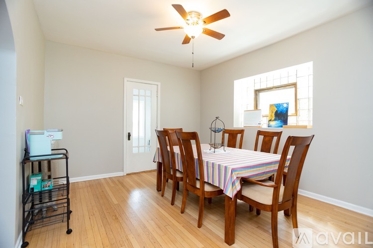 A dining room with a table and chairs.
