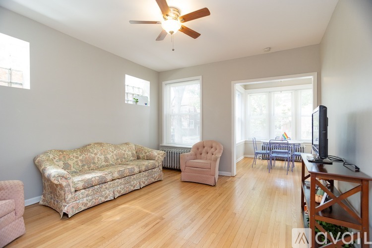 A living room with a couch, chair, and television.