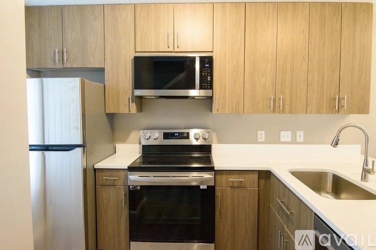 A kitchen with wooden cabinets and stainless steel appliances.