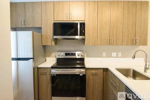 A kitchen with wooden cabinets and stainless steel appliances.