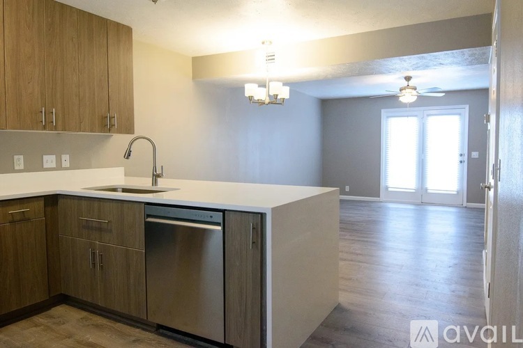 A kitchen with wooden cabinets and a white countertop.