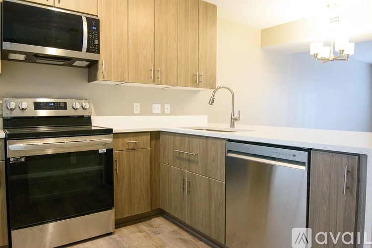 A kitchen with wooden cabinets and stainless steel appliances.