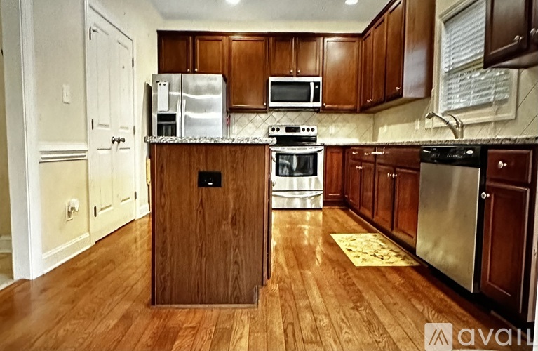 A kitchen with wooden cabinets and a white fridge.