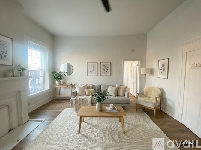 A living room with a fireplace, couches, and a coffee table.