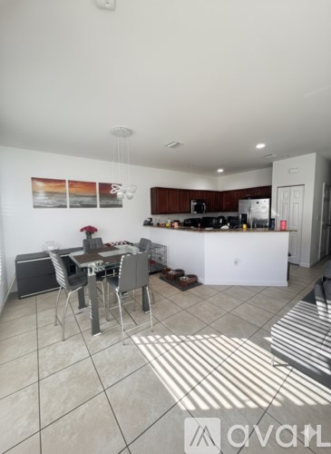 A kitchen with a table and chairs in the middle of the room.
