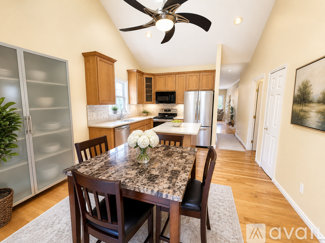 A kitchen with a table and chairs in the middle of the room.