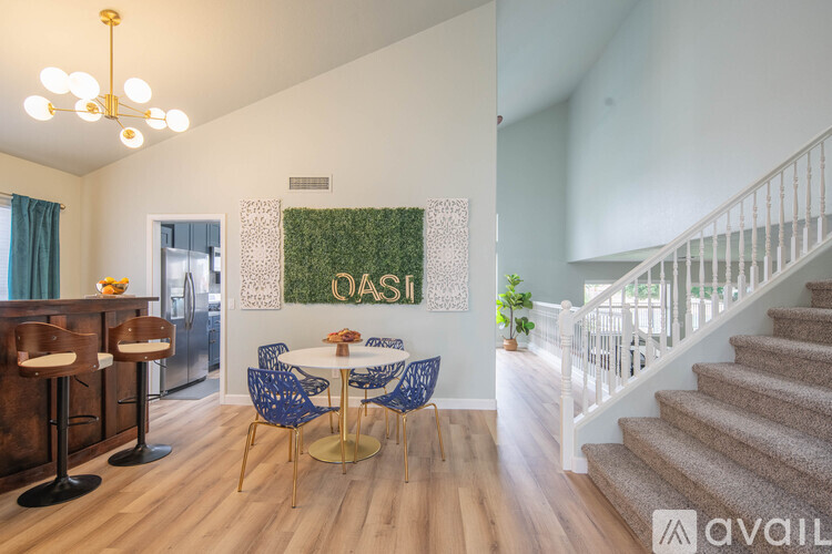 A living room with a dining table and chairs.
