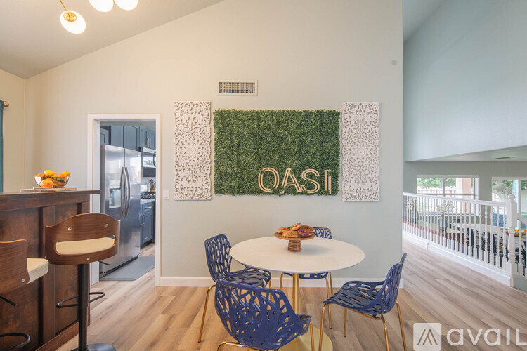 A dining area with a white table and blue chairs.