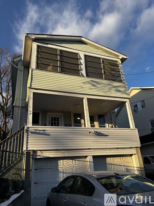 A two-story house with a garage in front.