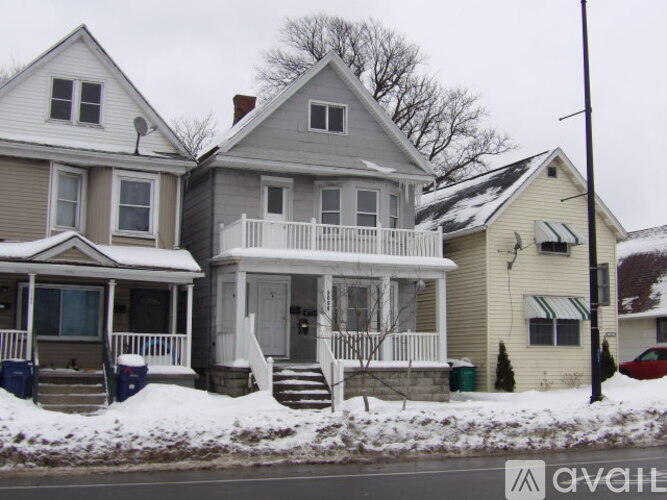 A house with a grey roof and a white porch.