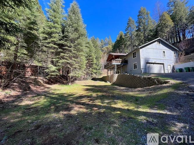 A house is surrounded by trees in a wooded area.