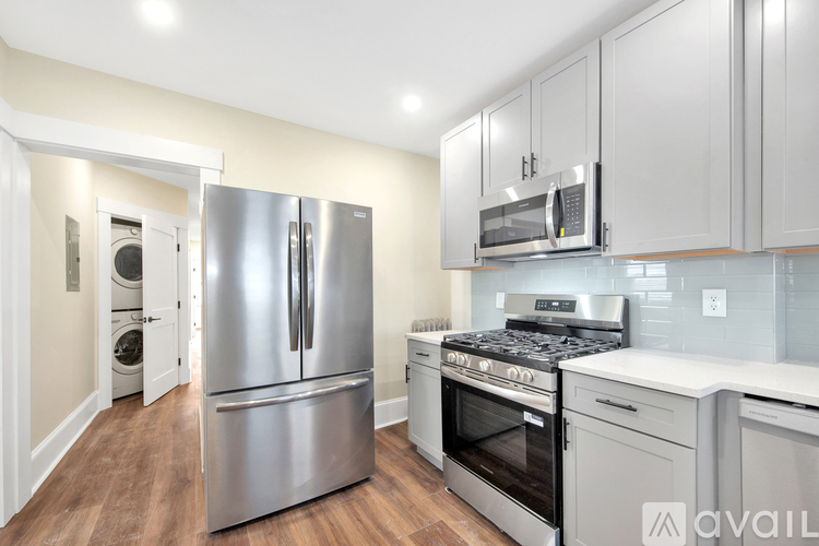 A kitchen with a stainless steel refrigerator and oven.