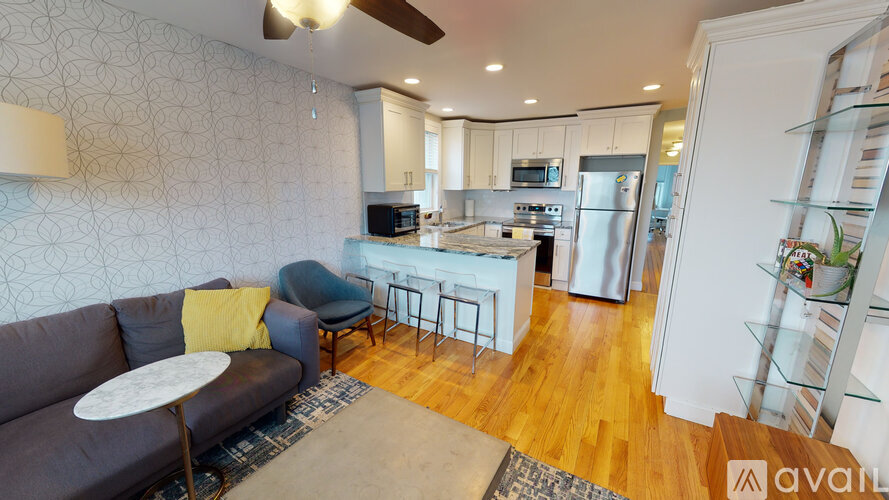 A modern kitchen with a dining table and chairs.