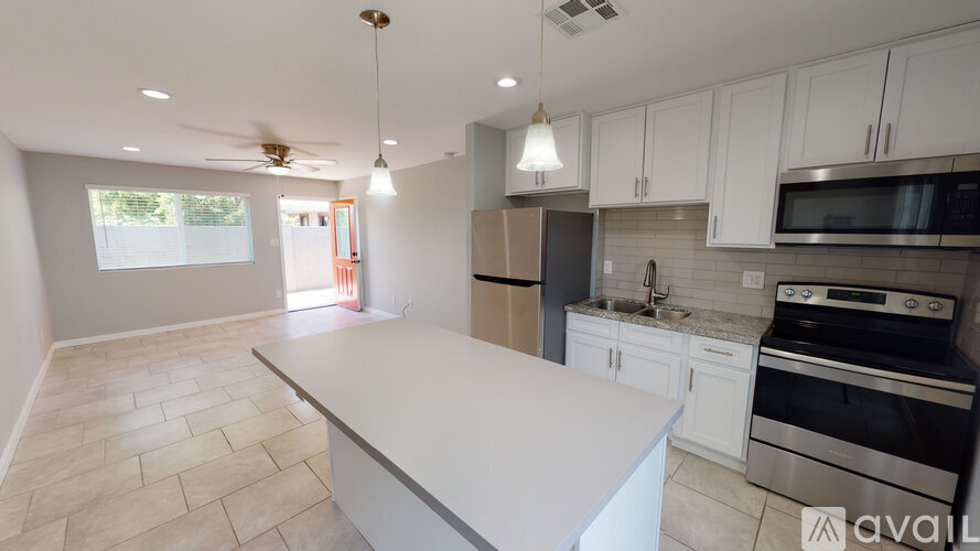 A kitchen with a white island in the middle of it.