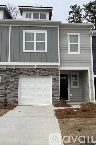 A house with a garage door in front.