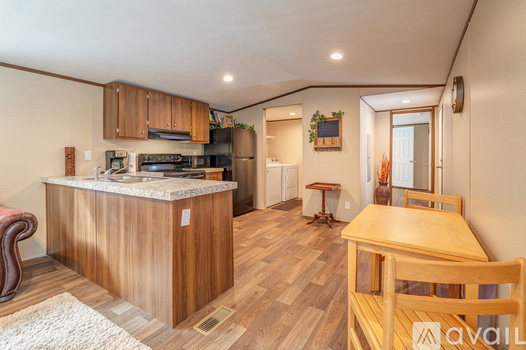 A kitchen with wooden cabinets and a marble countertop.