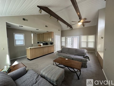 A living room with a grey couch and a wooden coffee table.