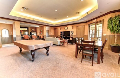 A living room with a large table and chairs.