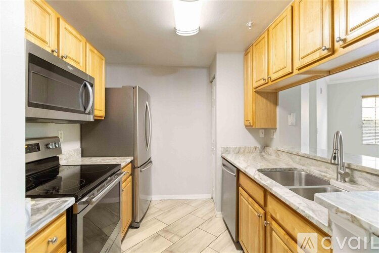 A kitchen with wooden cabinets and stainless steel appliances.