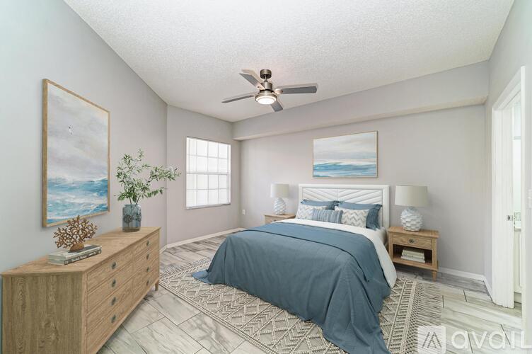 A bedroom with a bed, dresser, and ceiling fan.