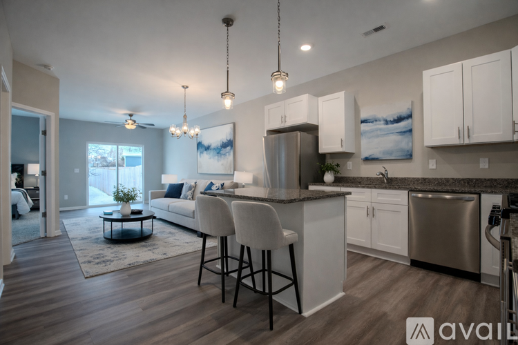 A modern kitchen with white cabinets and a large island.