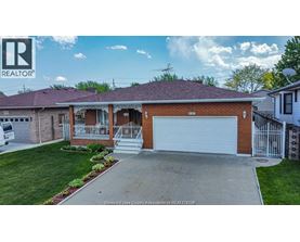A house with a garage and a sign that says REALTOR.