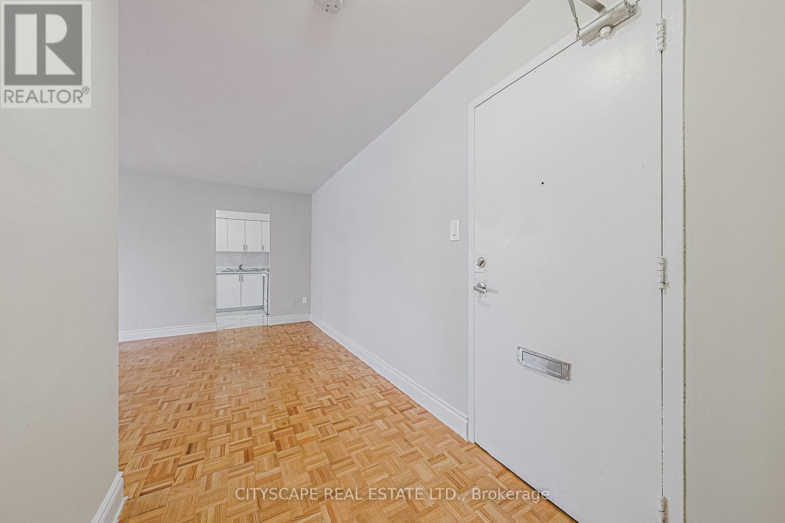 A room with a wooden floor and white walls.