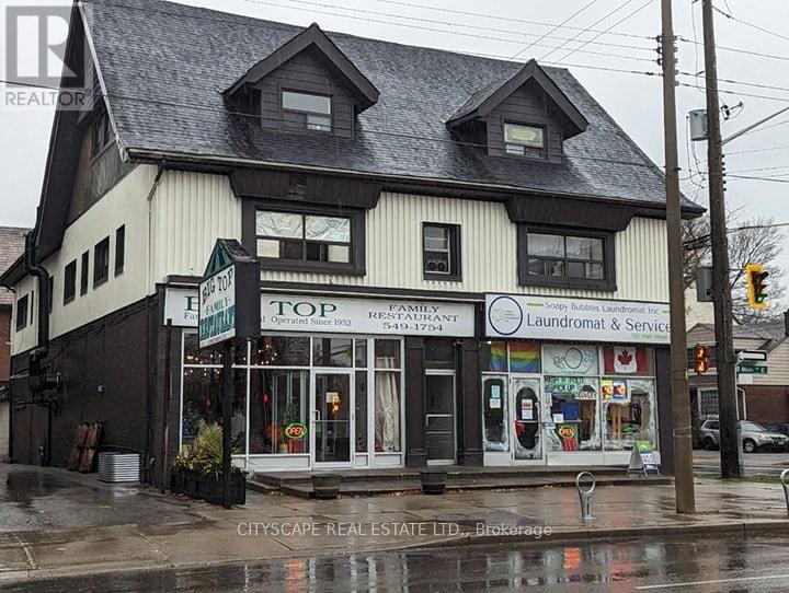 A building with a sign that says Top Family Restaurant Laundromat & Service.