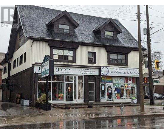 A building with a sign that says Top Family Restaurant Laundromat & Service.