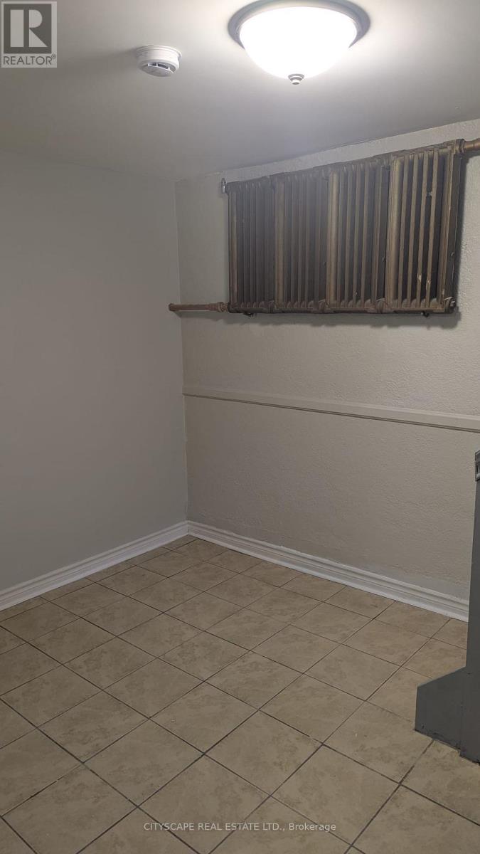 A room with beige walls and tiled flooring.