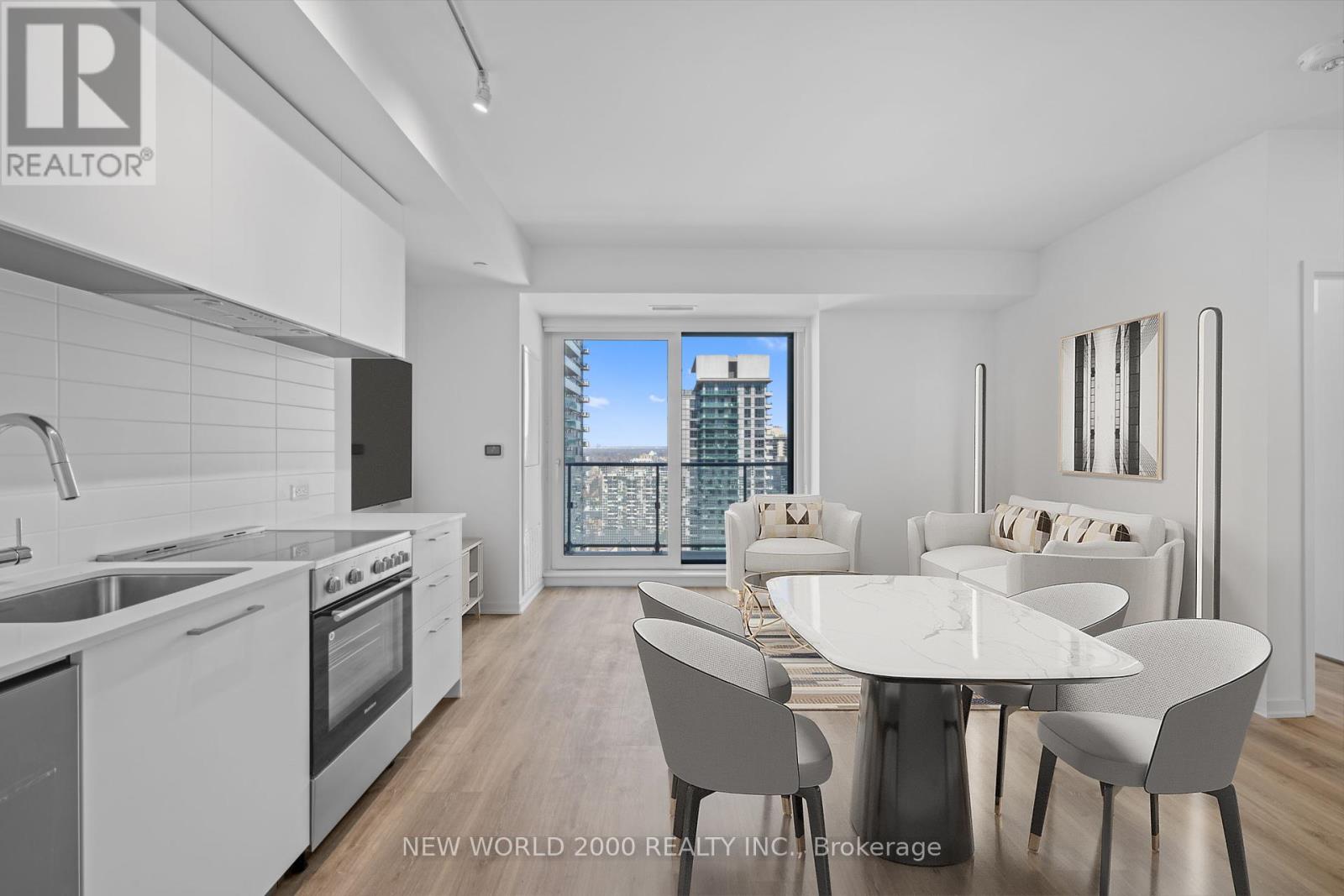 A modern kitchen with a dining table and chairs.