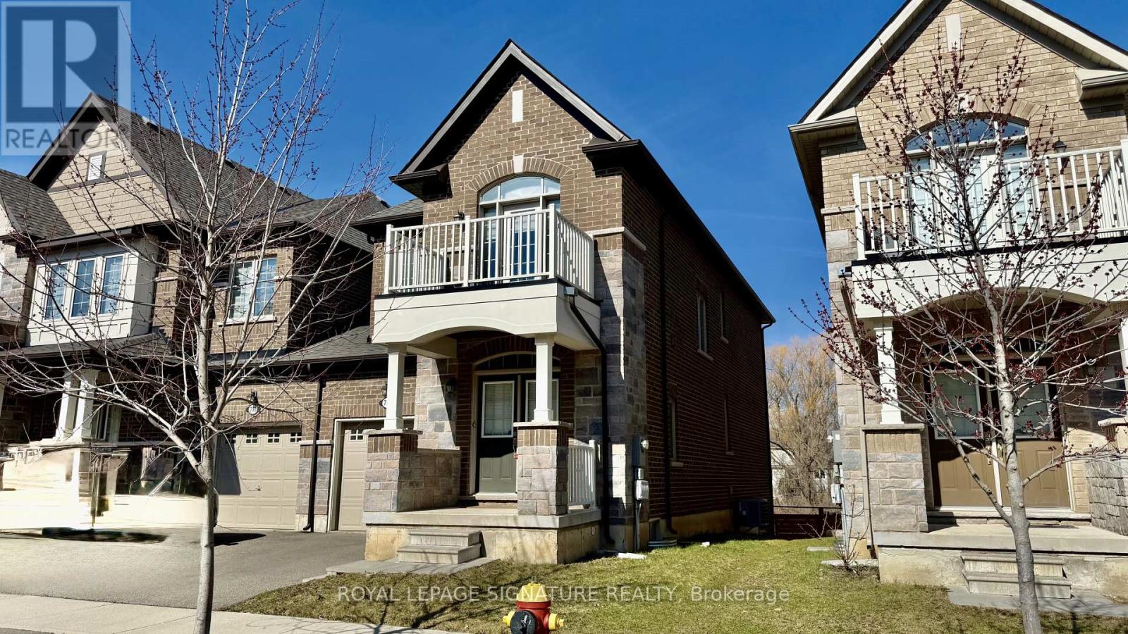A row of houses with a sign that says Royal LePage Signature Realty Brokerage.