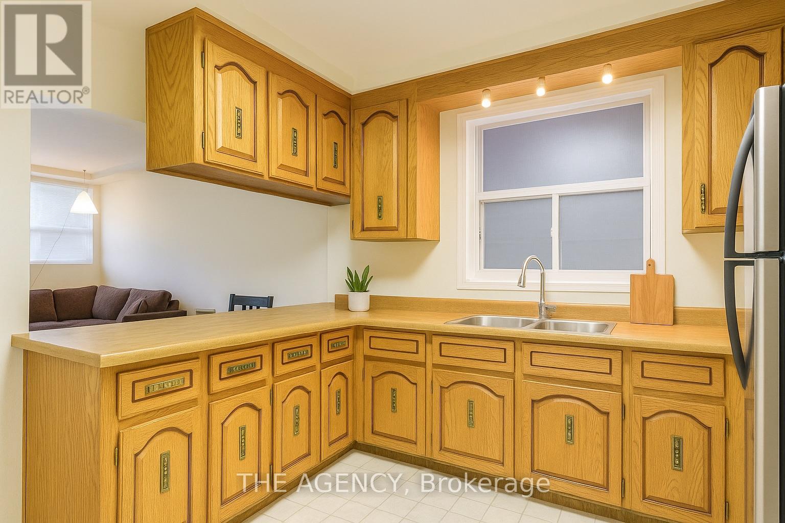 A kitchen with wooden cabinets and a sink.