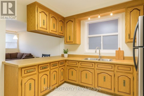 A kitchen with wooden cabinets and a sink.