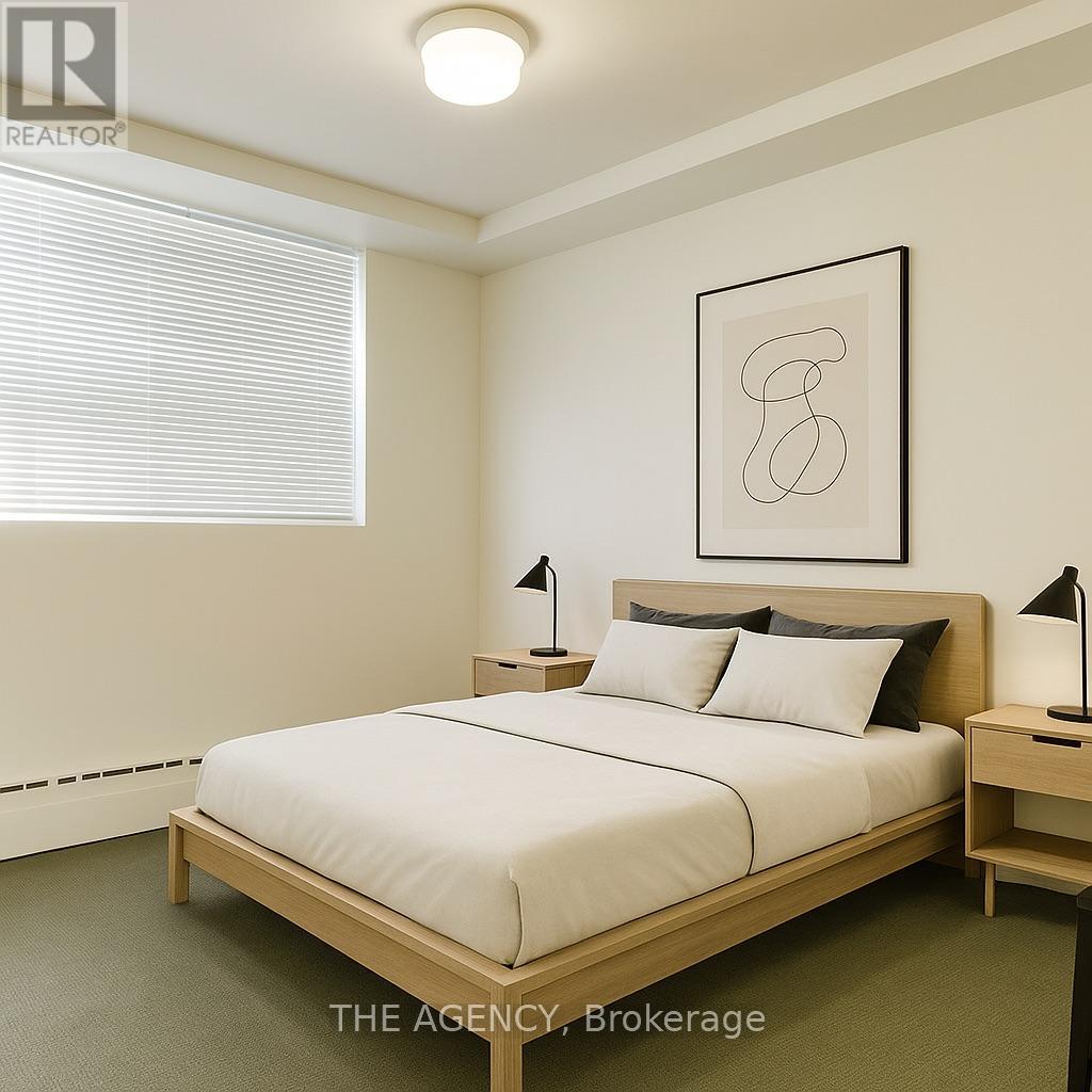 A bedroom with a bed, nightstands, and a framed artwork on the wall.