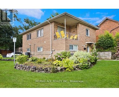 A house with a lawn and a sign that says RE/MAX ACE REALTY INC., Brokerage.