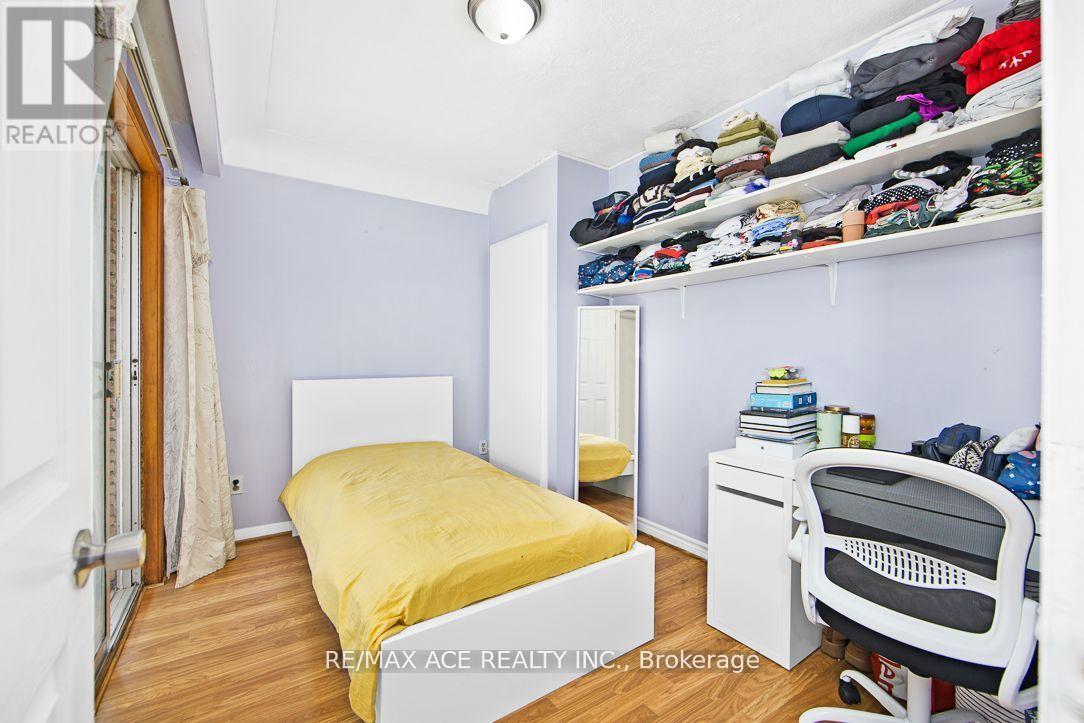 A bedroom with a bed, desk, and chair.