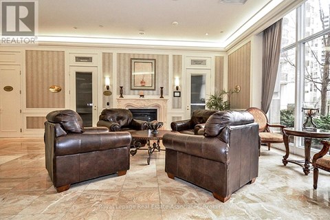 A living room with two brown leather sofas and a fireplace.